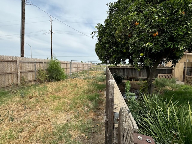 view of yard with a fenced backyard