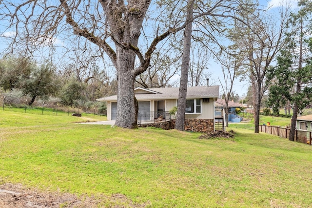 back of house featuring a lawn and a garage