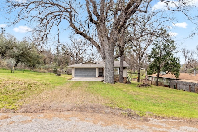 view of front of house with a front yard and a garage