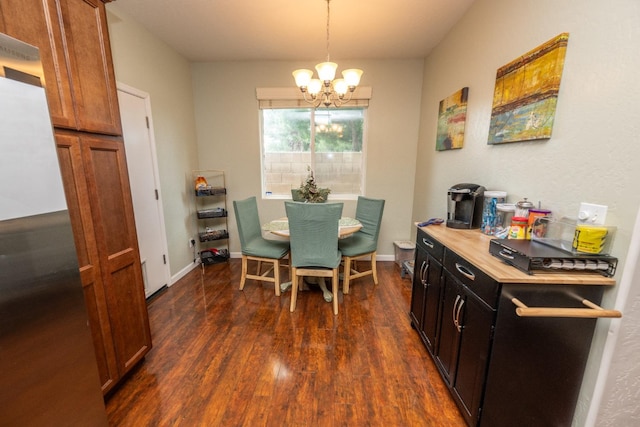 dining area with a notable chandelier and dark wood-type flooring