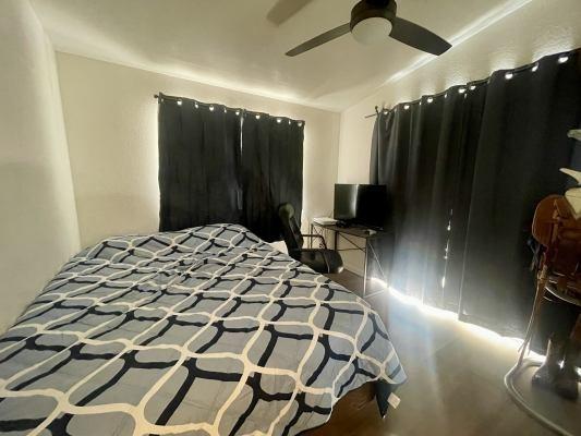 bedroom featuring ceiling fan and vaulted ceiling