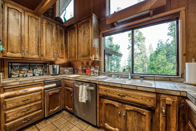 kitchen featuring dishwasher, sink, tile countertops, and light tile patterned floors