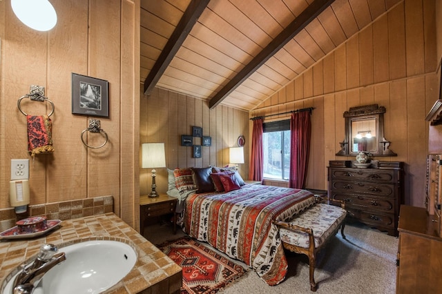 bedroom featuring sink, lofted ceiling with beams, wooden ceiling, and wood walls