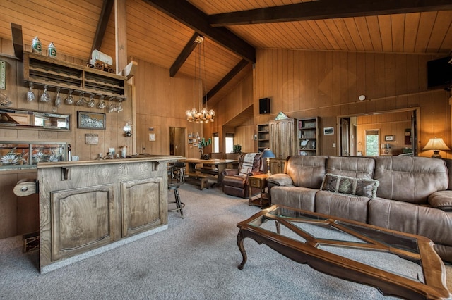 living room featuring wooden walls, high vaulted ceiling, carpet, a notable chandelier, and beamed ceiling