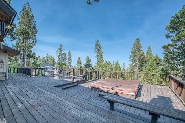 wooden terrace featuring a covered hot tub