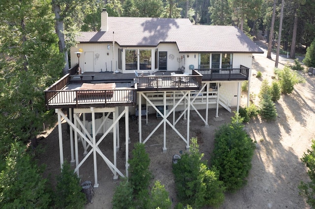 back of property featuring a deck