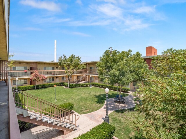 view of home's community featuring a lawn