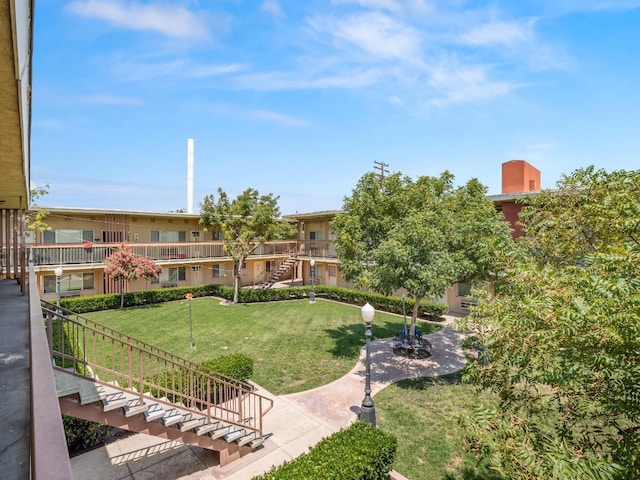 surrounding community featuring a lawn and stairway