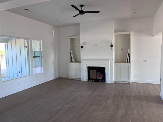 unfurnished living room featuring ceiling fan and hardwood / wood-style flooring