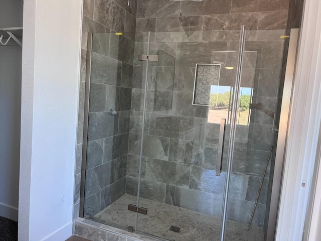 bathroom featuring a shower with shower door