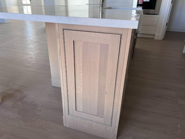 details with wood-type flooring and stainless steel oven