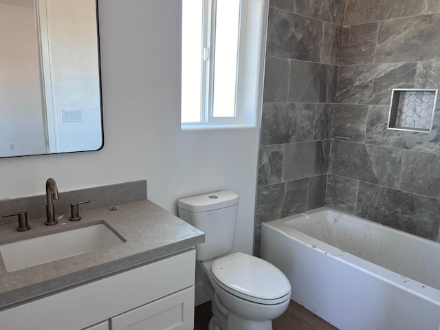 full bathroom with vanity, toilet, and tiled shower / bath