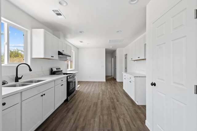 kitchen featuring white cabinetry, dark hardwood / wood-style flooring, sink, and stainless steel stove