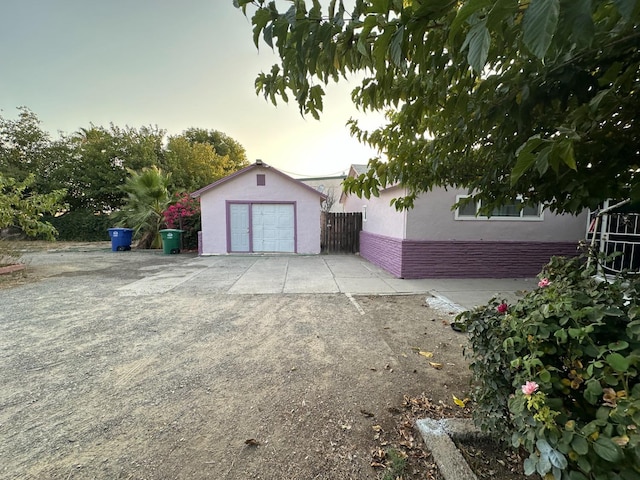 view of garage at dusk