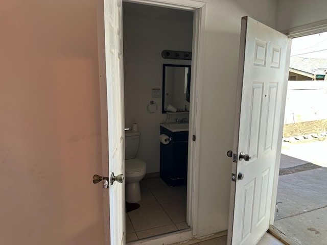 bathroom featuring vanity, tile patterned floors, and toilet