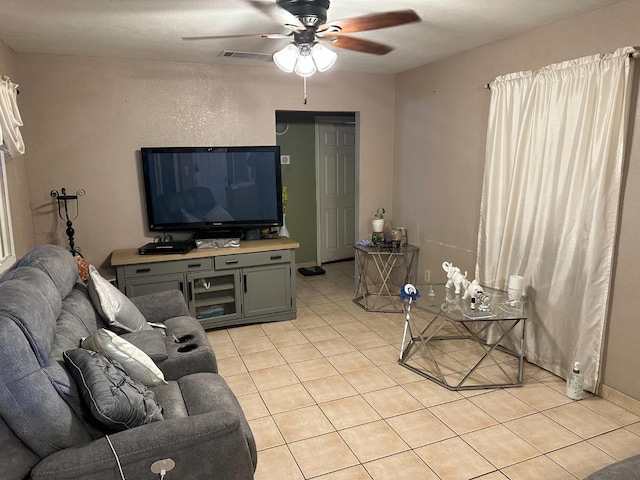 tiled living room featuring ceiling fan