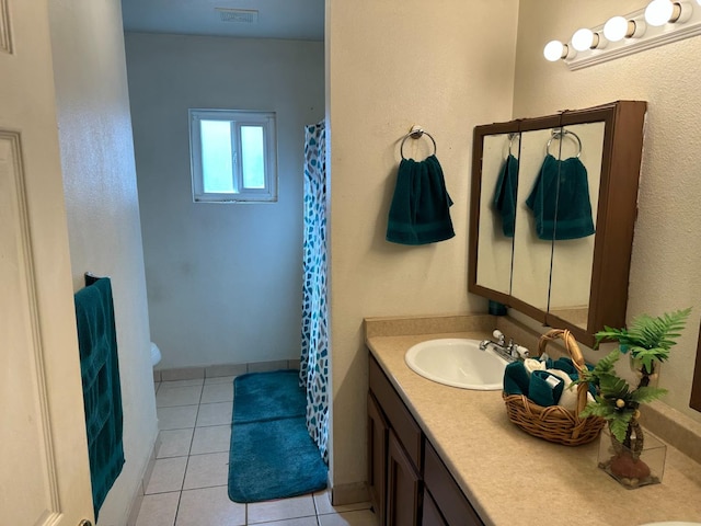 bathroom with vanity, tile patterned floors, and toilet