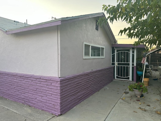 view of side of property featuring a patio