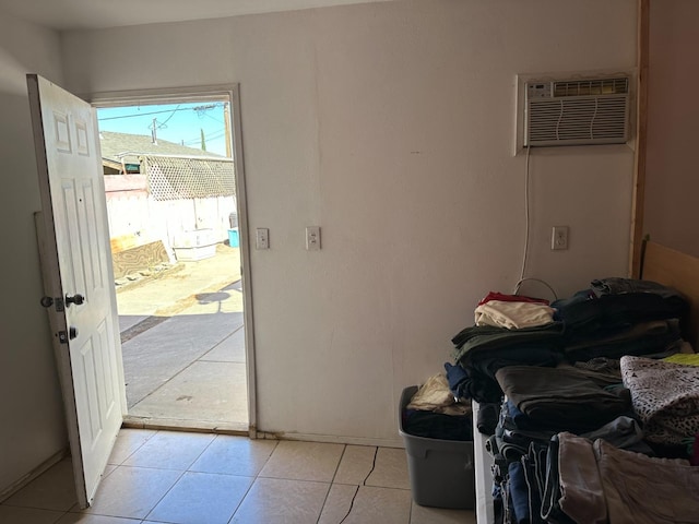 entryway featuring light tile patterned flooring and a wall mounted AC