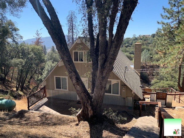 view of property exterior with a wooden deck