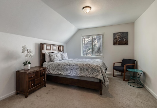 bedroom featuring light carpet, baseboards, and lofted ceiling