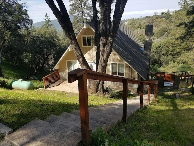 exterior space with a lawn and a chimney