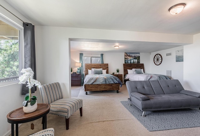 bedroom featuring light carpet and visible vents