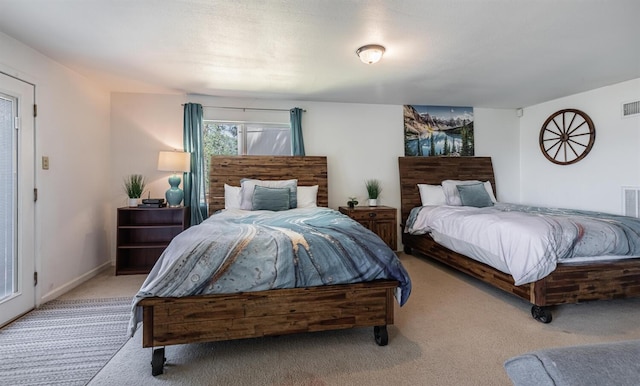 bedroom featuring baseboards, visible vents, and light colored carpet