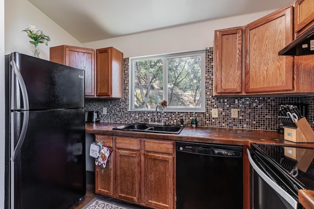 kitchen with a sink, ventilation hood, decorative backsplash, black appliances, and dark countertops