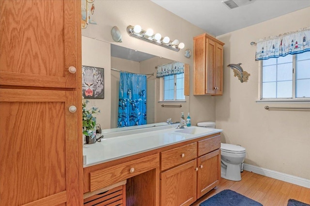 bathroom with toilet, hardwood / wood-style flooring, and vanity