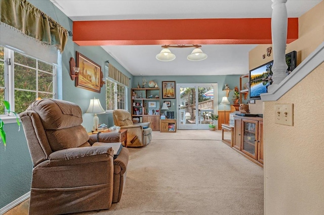 sitting room featuring carpet floors, beamed ceiling, and decorative columns