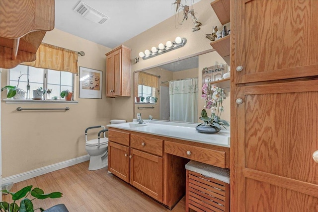 bathroom featuring vanity, curtained shower, wood-type flooring, and toilet