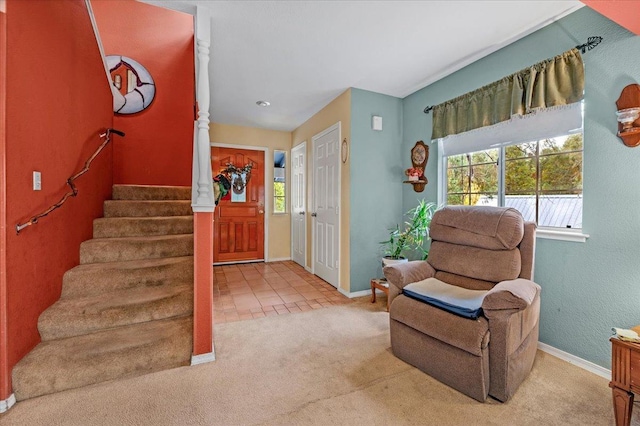 foyer entrance with carpet floors and a healthy amount of sunlight