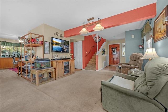 living room with light carpet, plenty of natural light, and ceiling fan