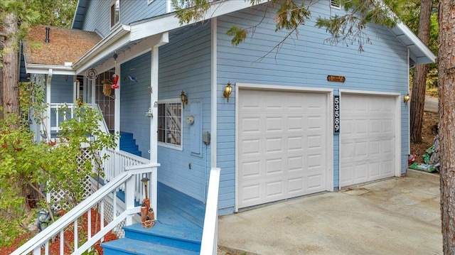 view of home's exterior with covered porch and a garage