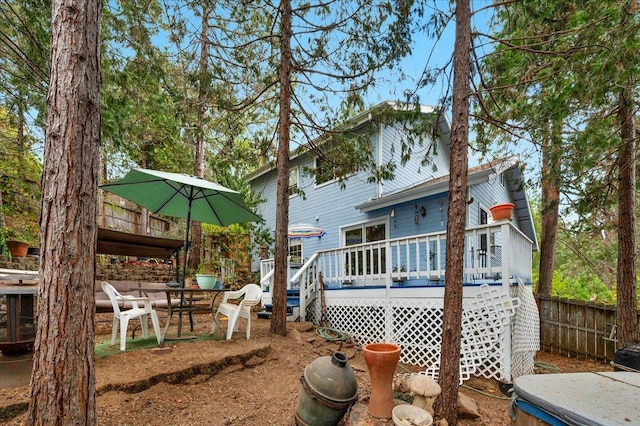 rear view of property featuring a deck