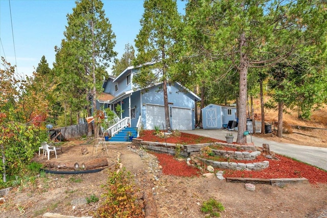 view of front of house featuring a storage shed and a garage