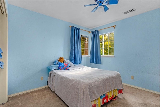 bedroom with light colored carpet and ceiling fan