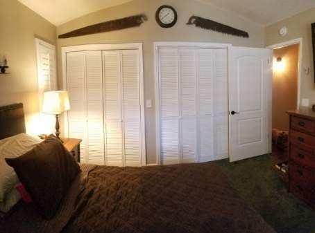 bedroom featuring lofted ceiling and two closets