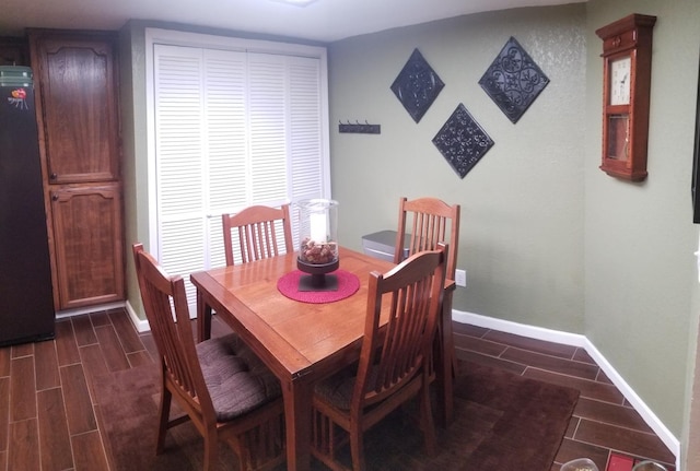 dining space with dark hardwood / wood-style flooring