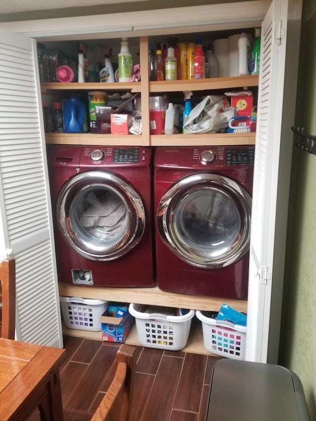 clothes washing area with washing machine and dryer