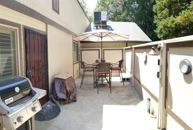 view of patio with area for grilling and central AC unit