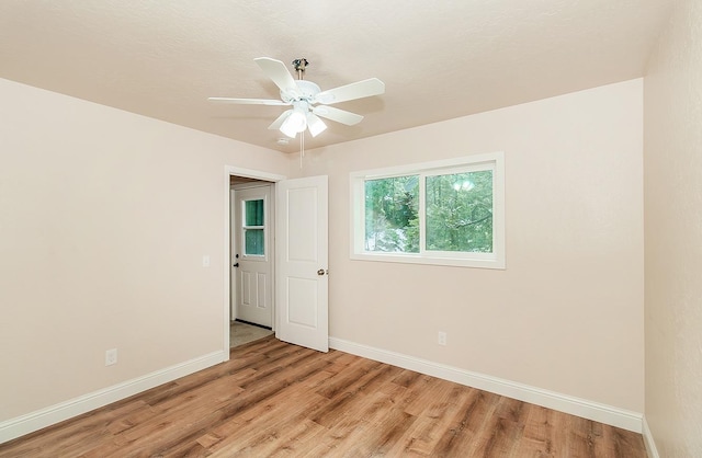 unfurnished room with ceiling fan and light hardwood / wood-style floors