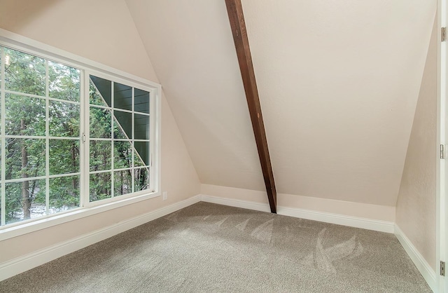 bonus room with carpet flooring and lofted ceiling with beams