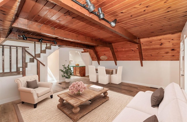 living room with vaulted ceiling with beams, wooden ceiling, and hardwood / wood-style flooring