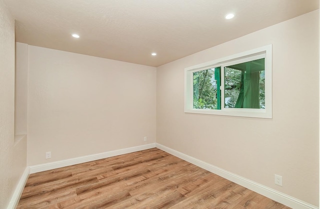 empty room with light hardwood / wood-style floors