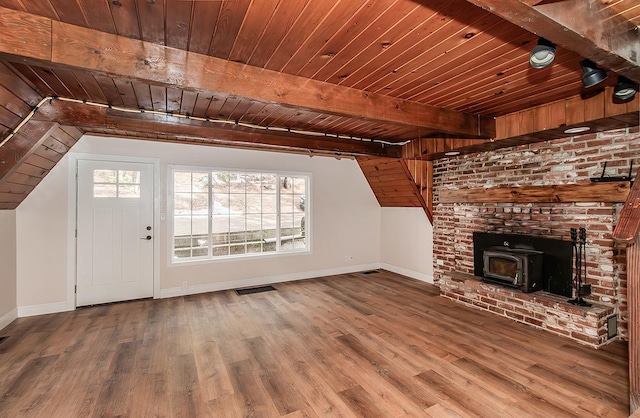 unfurnished living room with a fireplace, wooden ceiling, wood-type flooring, and a wood stove