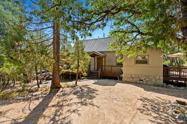 view of front of house featuring crawl space, metal roof, and a deck