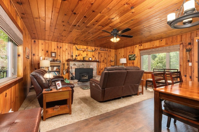 living room with wood ceiling, dark wood-type flooring, a healthy amount of sunlight, and wood walls