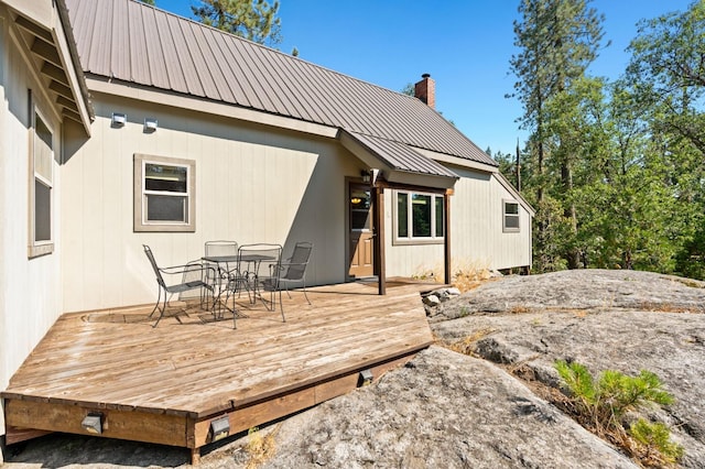 rear view of house featuring a wooden deck